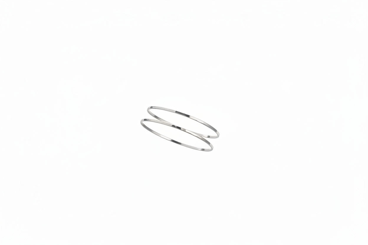 Silver bracelet on a person's wrist with a white background